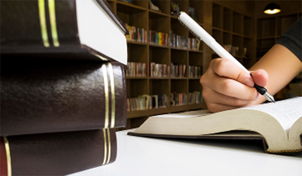 person writing in book